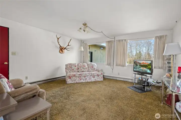 Living room with door to three-car garage.