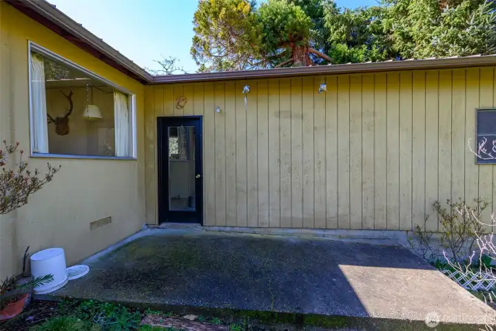 Patio with door into attached 3-car garage.