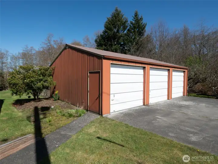 Detached 3-bay shop with sidewalk from house to side door.