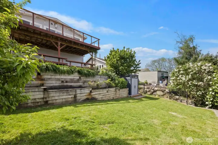 Beautifully terraced yard with outbuilding.