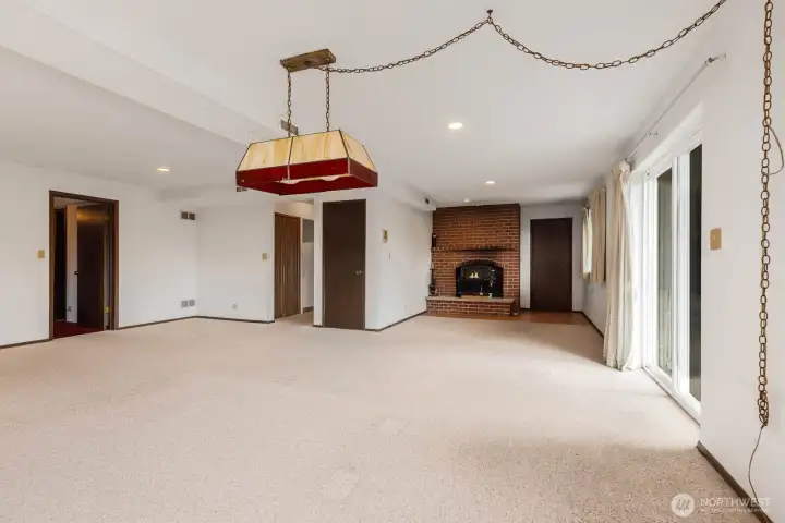 Exit to the garage, private slider access to the outdoors, 1 additional bedroom, 1 non-conforming bed, guest bath and utility room down the hall