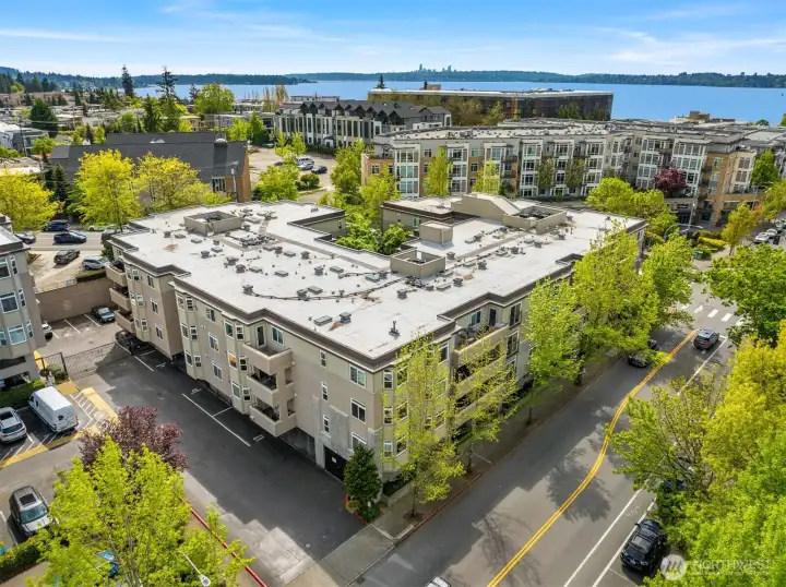 Plaza on State - Unit is on this corner, second level from top, with covered deck on the right partially obscured by trees.