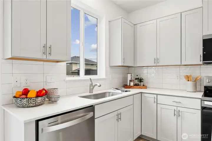 White backsplash and stainless steel appliances. White backsplash and stainless steel appliances.