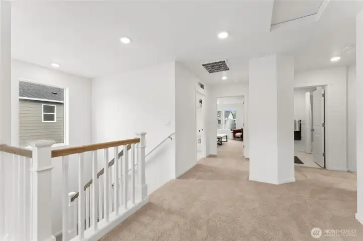 Open wooden stair railing and wide-open hallways upstairds. Open wooden stair railing and wide-open hallways upstairds.