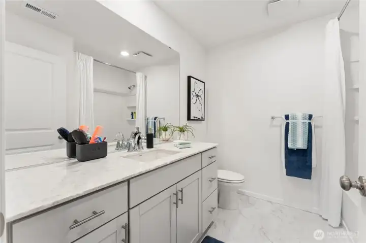 Secondary bath with large quartz countertop. Secondary bath with large quartz countertop.