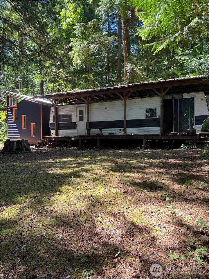main trailer w/covered roof and large deck.
