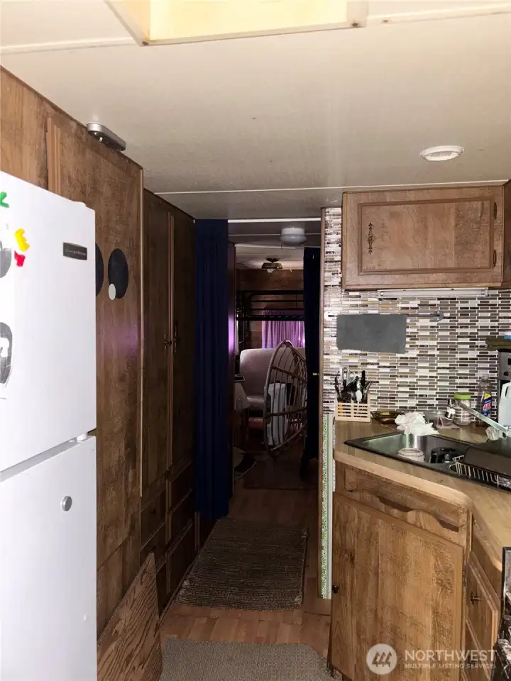 Galley kitchen looking towards the bedroom.
