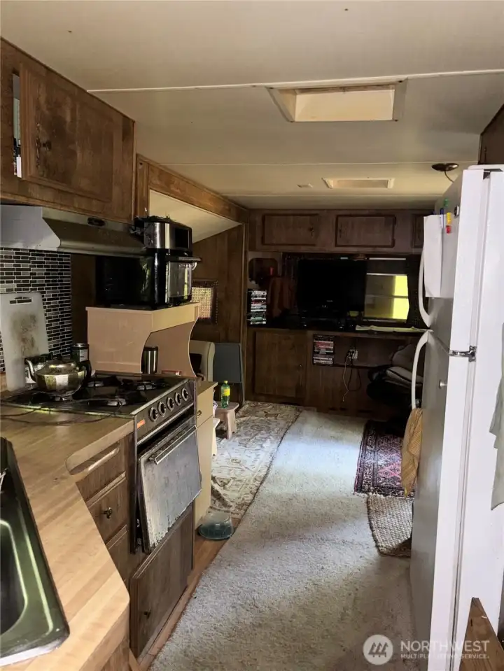 Galley kitchen looking towards the living area w/sitting area and pull out couch.