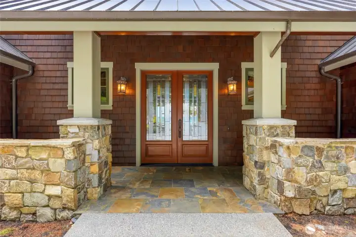 Stone wall porch entry with custom doors
