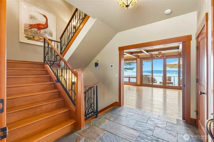 Slate floors compliment the custom staircases with iron finishes