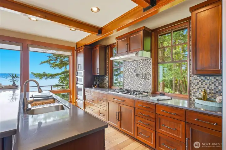 Corian countertops with custom tile backsplash and cherry cabintetry