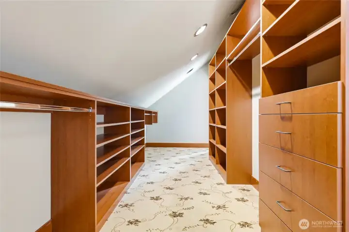 Huge walk-in closet with doors at both ends and built in everything!