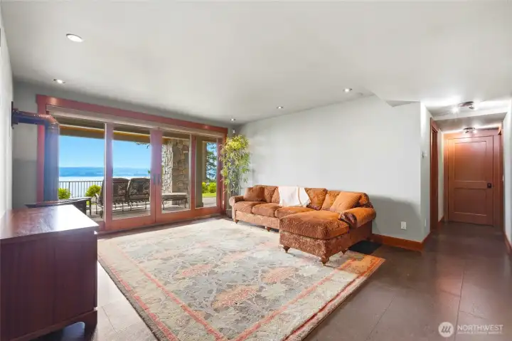 Lower level great room/entertainment with covered patio and more amazing views of Whidbey island and the Olympic Mountains