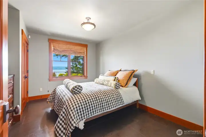 Lower level bedroom with dual closets and built-in dresser