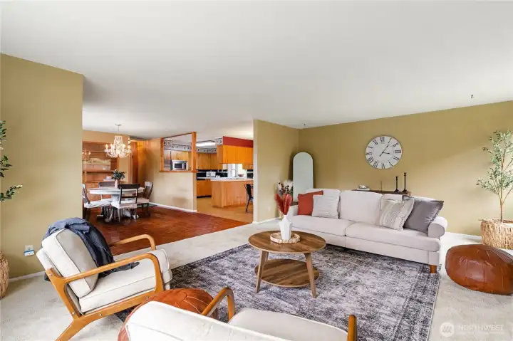 Living room looking towards kitchen and formal dining room. Entrance of the home is to the left.