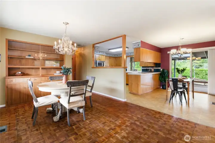 Rarely found today, the custom walnut built-in dining hutch showcases the home's exceptional craftsmanship, perfectly paired with beautiful teak parquet flooring.