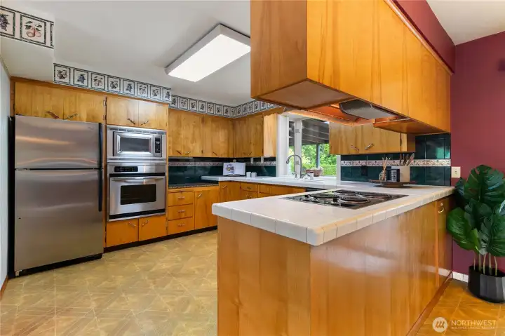 Beautiful maple cabinetry is the standout feature of this spacious kitchen, offering abundant storage for all your cookware, small appliances, and kitchen essentials.