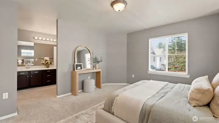 A primary bedroom designed for relaxation. Enjoy a bright, generous layout that leads perfectly into a private bathroom with rich espresso cabinetry and ample counter space A primary bedroom designed for relaxation. Enjoy a bright, generous layout that leads perfectly into a private bathroom with rich espresso cabinetry and ample counter space