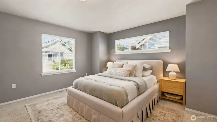 Retreat to this spacious and light-filled primary bedroom. Retreat to this spacious and light-filled primary bedroom.