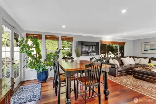 There is plenty of space for additional dining options --surrounded by windows for natural light and french doors to back patios and garden space.