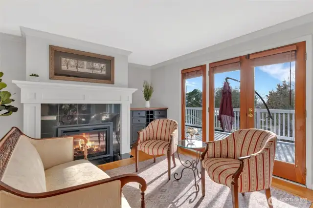Formal living room with gas fireplace and french doors leading to spacious west facing deck.