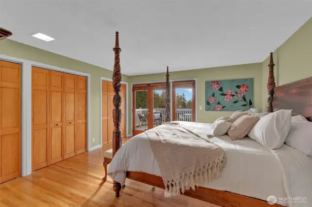 One of 2 primary suites.  The upper level suite has french doors leading to the spacious deck and windows for natural light.