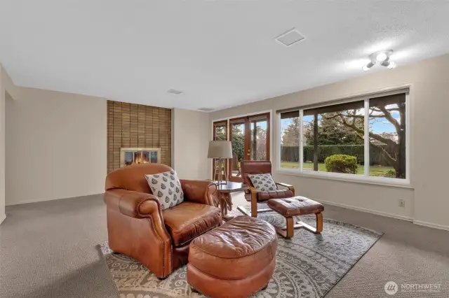 Extra spacious lower level has additional full living area with french doors leading to the front patio/garden yard.  There is a wood burning fireplace, and large windows for additional natural light.