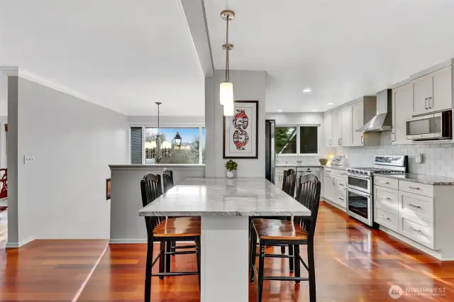 Kitchen has island/eating bar for informal dining, and ample cabinets for storage.