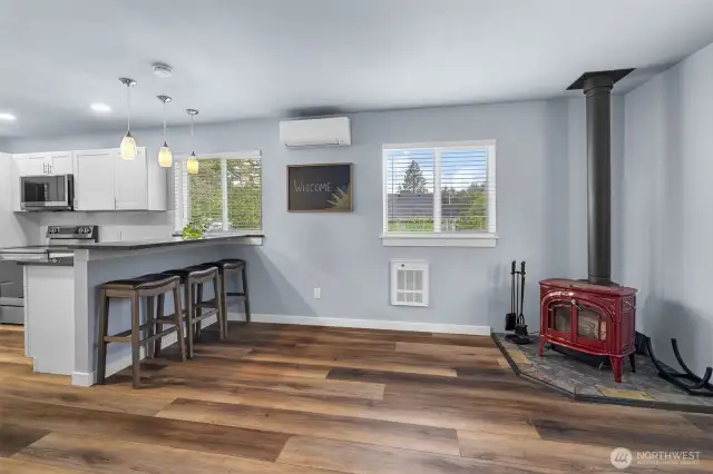 Free standing wood fireplace brings ambiance and winter warmth to the open concept floor plan.