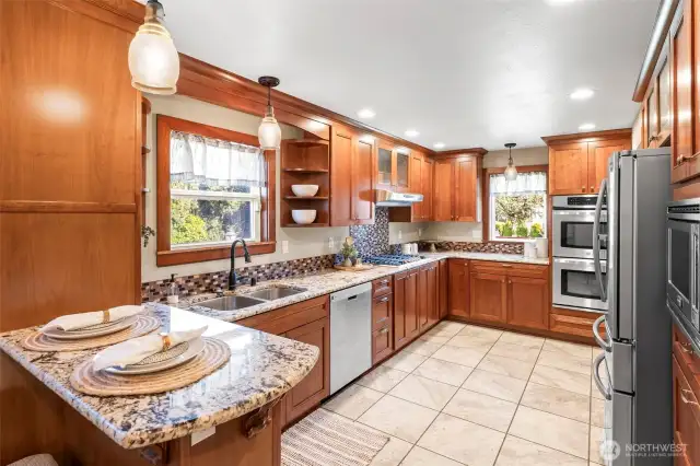Remodeled kitchen with granite counters and custom cabinetry throughout.