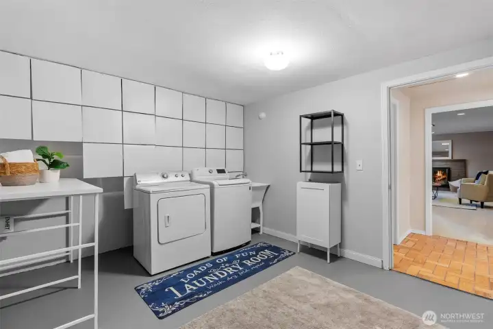 Laundry room with folding table, dry lock floor, and a giant storage closet!