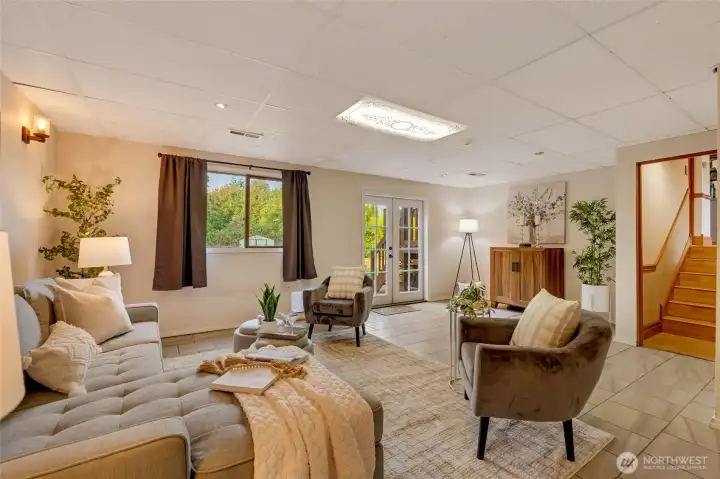 Step downstairs to a spacious family room designed for comfort and gatherings.
