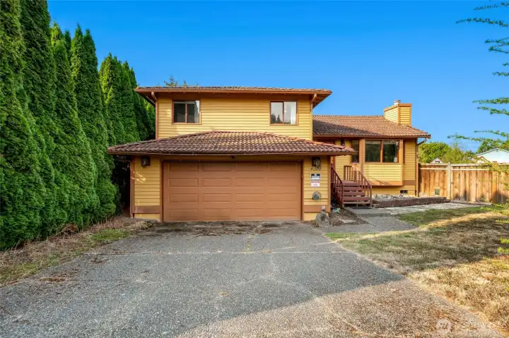 Large garage with a workshop setup, perfect for hobbies, projects, or extra storage.