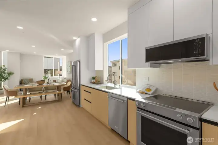 Large kitchen area with sleek cabinets and beautiful backsplash