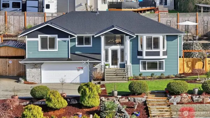 Thoughtfully placed windows maximize the views and flood the home with natural light, complementing the inviting front porch and open, airy design.