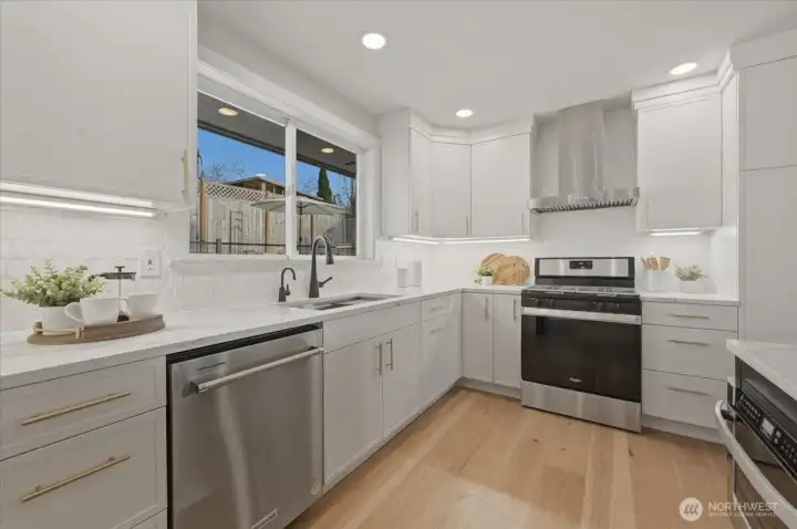 Thoughtfully designed with custom cabinetry featuring pull-out drawers, under-cabinet lighting and abundant storage. Stainless steel appliances, a microwave drawer, workstation sink with touch-activated faucet, and instant hot water make this kitchen as functional as it is beautiful.