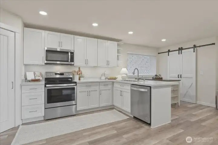 The lower level features a fully equipped secondary kitchen with stainless steel appliances, quartz countertop and a walk-in pantry -- creating a complete mother-in-law suite ideal for multi generational living, guests or flexible lifestyle needs.