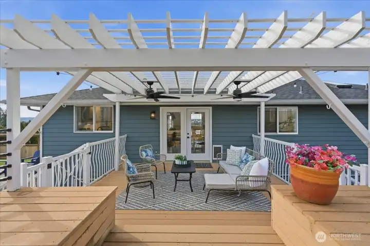 An inviting covered sitting area just off of the kitchen and dining rooms -- complete with ceiling fans for summer breezes.
