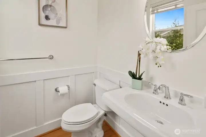 The main-floor guest bathroom features a classic pedestal sink and clean, tasteful finishes.