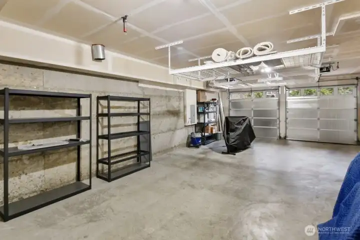 This massive 2-3 car tandem garage offers more than just parking it's a flexible space for a home gym, workshop, or the ultimate hobby station with plenty of room to spare for storage.