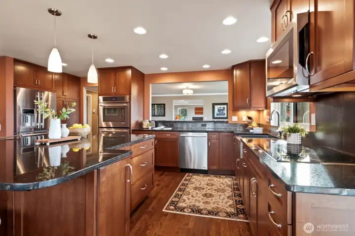 updated kitchen, with hardwood cabinets and hardwood floors.