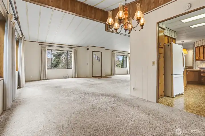 Formal dining room with vaulted ceilings, opens to the living room overlooking the lake.