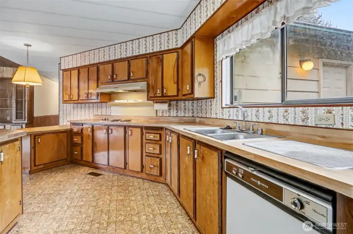 Spacious kitchen with plenty of counter and cabinet space and an eating bar opens to the family room.