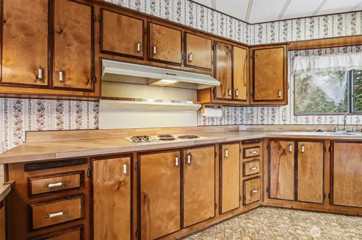 Spacious kitchen with plenty of counter and cabinet space and an eating bar opens to the family room.