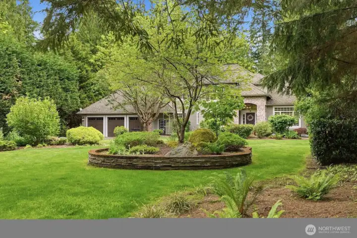 Lush front yard landscaping with sprinklers. Lush front yard landscaping with sprinklers.