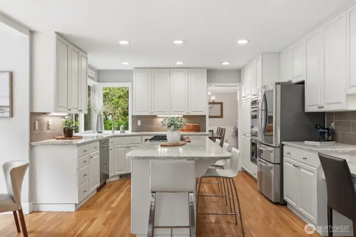 Island with 5 burner gas cooktop and breakfast bar seating. Island with 5 burner gas cooktop and breakfast bar seating.