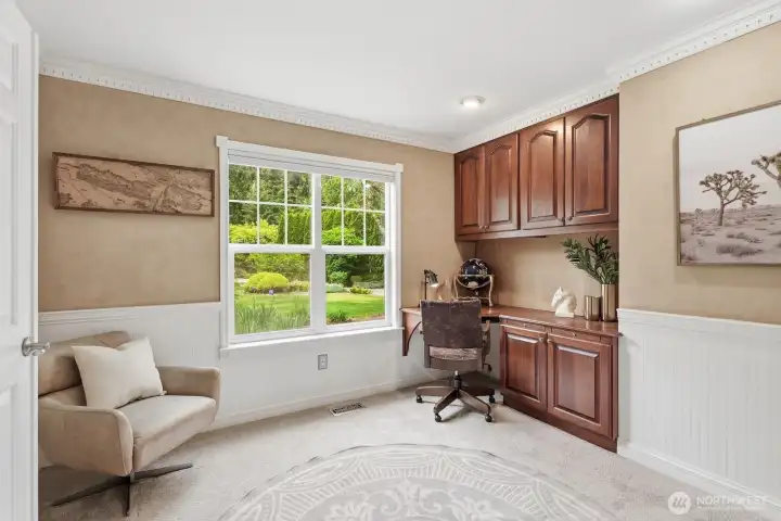 Charming office with built-in desk and cabinetry, crown molding and bead board wainscoting. Charming office with built-in desk and cabinetry, crown molding and bead board wainscoting.