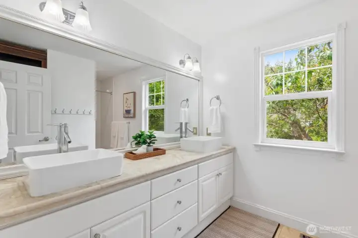 Hall bath updated with travertine floor and vanity with floating china sinks. Hall bath updated with travertine floor and vanity with floating china sinks.