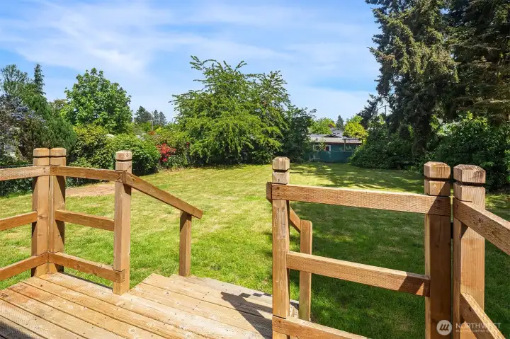 Spacious backyard with deck.