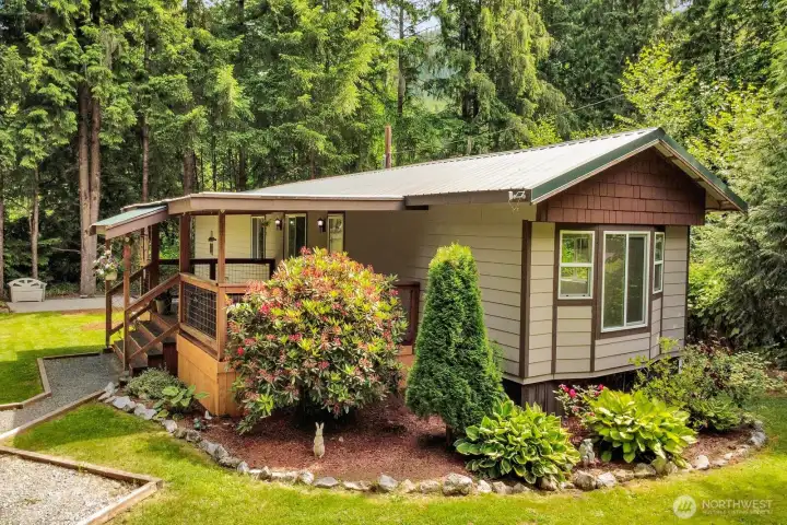Front corner view showcasing the home's welcoming entry and attractive setting.